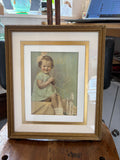 Hand-coloured 1940s studio photograph of a child in a gilt frame, full view