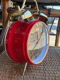 Chinese Cultural Revolution alarm clock, angled view showing red case and dial