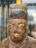 Front close-up of face and age split to hat on antique Chinese carved figure