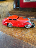 Side view of vintage Schuco clockwork sedan toy car