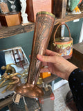 	Copper vase held in hand showing full profile, brass rim and poppy design