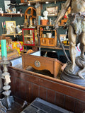 Vintage oak lectern displayed among antique shop stock, wide view