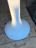 Close-up of Bonaldo Eos lamp stem and round base, lit from within