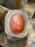 Top view of red hat finial on antique Chinese carved wood official figure