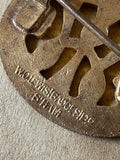 Close-up of maker's mark on back of WW2 WI enamel badge.