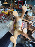 View of the underside of the vintage ceramic tiger planter held in hand, showing the plain unglazed terracotta-coloured base with the four legs and the underside of the saddle planter visible.