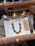 Florenza 1950s peridot green rhinestone and faux pearl necklace displayed in a cream jewellery presentation box inside a vintage display case, priced at £250, with handwritten tag.
