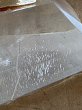 Base of plexiglass lighthouse souvenir showing scratches