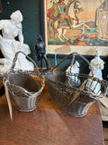 Two woven wire wine baskets shown from above 