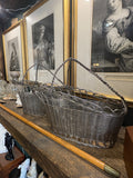 	Two wine baskets angled together on a shelf, showing handles and woven sides