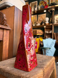 West German Fat Lava vase, front view, showing red and orange glaze with dark bubbled craters.