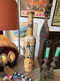 Ceramic Cinzano advertising bottle, front view, showing zebra and bottle design against room setting.