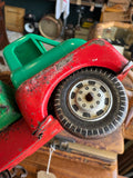 Close-up of front wheel and rubber tyre on vintage Wells-Brimtoy 1950s tinplate flatbed truck