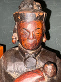 Close-up of painted face and black robe on antique Chinese Guanyin figure