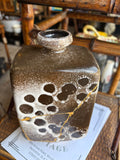 Strehla pottery vase showing narrow neck and crater glaze texture