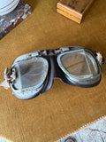 Vintage WWII-era RAF pattern split lens flying goggles with grey metal frame and leather padding