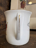 Handle detail of WWI commemorative cup showing gilt 