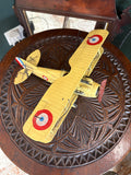 Top-down view of yellow Nieuport 17 metal biplane model showing French tricolour roundels on wings
