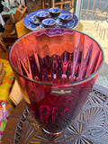 View looking down into the open rim of the Dartington Crystal cranberry vase, showing the optical ribbed interior pattern and the intense ruby colouring of the glass body.