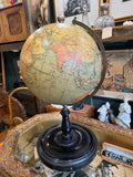 Philip's 9 inch globe c.1920s showing India, Arabia and the Indian Ocean, on a brass meridian and ebonised turned wooden base