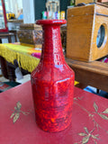 Mottled red 1970s ceramic bottle vase, front facing detail shot