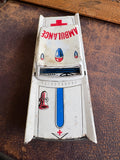 Top-down view of vintage Japanese tinplate ambulance showing roof lithography and Ambulance text