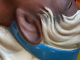 Close-up of ear and hair detail on ceramic wall mask