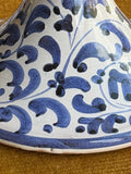 Detail of hand painted blue foliate pattern on vintage Italian ceramic candle holder