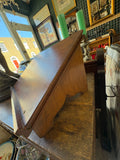 Side profile of vintage oak book stand on antique shop table