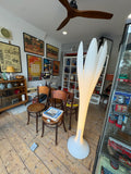 Bonaldo Eos floor lamp standing in vintage shop room full of collectibles