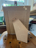 Reverse side of Art Deco photo frame showing easel back and fabric covering