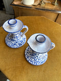 Top view of hand painted Italian ceramic chamberstick candle holders in blue and white