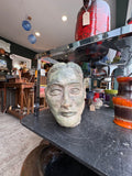 Plaster maquette head displayed on shop shelf
