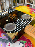 Close up of Cohiba Behike cigar box guitar body with speaker grilles