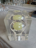 Top view of clear acrylic cube paperweight with embedded light bulb