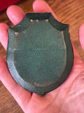 Green textured leather back of antique shield-shaped photograph case, c. 1880-1910. 