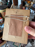 Reverse of antique frame showing hanging cord and backing