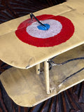 Close-up of French tricolour roundel on upper wing of yellow Nieuport 17 biplane model