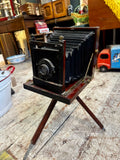 Victorian mahogany folding plate camera with extended bellows on tripod by W Watson & Sons London