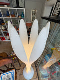Overhead view of Bonaldo Eos lamp showing sculptural white petal shades, lit