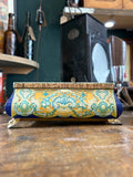 Side view of ornate Soviet sweet tin with claw feet