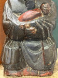 Carved black robes and red-swaddled infant on antique Chinese wood figure