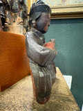 Side profile of antique Chinese carved wood Guanyin figure holding child