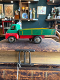 Side profile of vintage Wells-Brimtoy 1950s tinplate clockwork flatbed truck showing full length