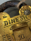 Close-up of Dinesh maker’s name stamped on padlock front face