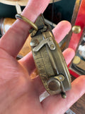 Side view of compass in hand, showing adjustment dial and scale markings