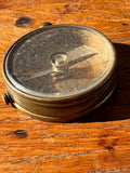 Vintage button compass side view showing depth