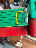 Close-up of lithographed green and yellow side panel detail on Wells-Brimtoy 1950s tinplate flatbed truck