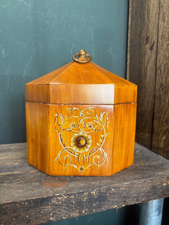 Octagonal toleware tea caddy with floral motif and loop handle