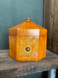 Octagonal toleware tea caddy with floral motif and loop handle